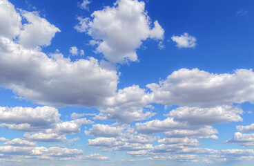 Clouds move in the blue sky. Tropical sky at day time, white and blue colors. Transparent clouds layers. A clear blue sky adorned with fluffy white clouds. Calm serene day. Sky background.
