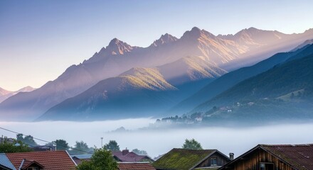 A scenic view of a mountain range with fog in the valley and a village at sunrise.