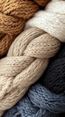 Close-up of braided yarn strands in various warm colors, showcasing texture and detail.