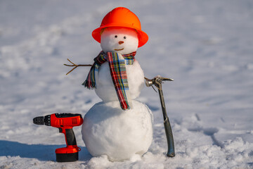 Snowman builder promotes hardware store tools. Snowman advert shows winter hardware store gear. Hardware store in winter. Cute snowman advertises seasonal hardware sale.
