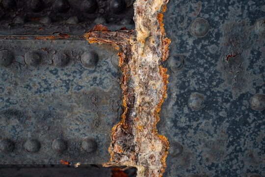 Bridge corrosion for civil engineering. Checker plate rust for heavy industry. Rusty metal grid for security themes. Wall corrosion for maintenance content. Rust texture for technology visuals.