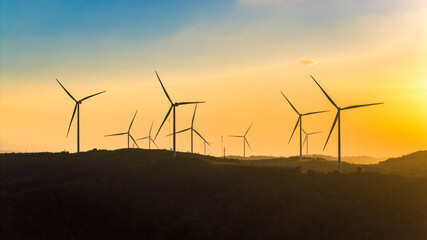 Aerial view of windmill turbines park generating green energy electric.Solar panels park and wind turbines at sunset.Green energy reduce carbon emissions and makes earth cleaner, Quang Tri, Vietnam