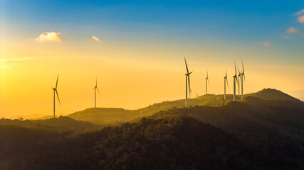 Aerial view of windmill turbines park generating green energy electric.Solar panels park and wind turbines at sunset.Green energy reduce carbon emissions and makes earth cleaner, Quang Tri, Vietnam