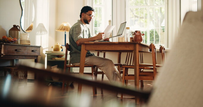 Reading, paperwork and man with laptop, confused and freelance contract for design project and home. Review, clause and person with documents for remote work, graphic designer and puzzled in house