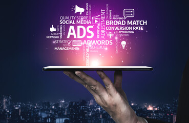 This image illustrates a hand holding a tablet displaying concepts related to digital advertising strategies, emphasizing quality, conversion rates, and social media relevance in marketing. Tessel
