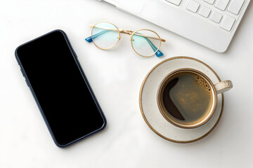 Smartphone and coffee cup with keyboard and glasses on a white desk for productivity