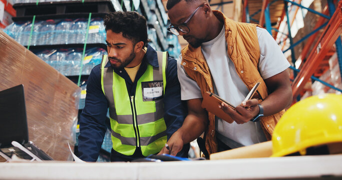 Business people, laptop and discussion in warehouse for logistics, meeting for supply chain collaboration. Low angle, tech and documents in storage facility for export, delivery service or supplier - Powered by Adobe