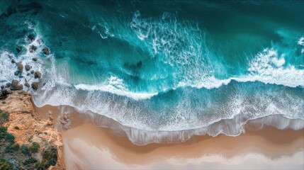 The ocean is calm and the waves are small. The beach is rocky and the water is blue