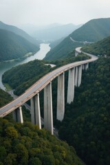 Modern concrete viaduct bridge spanning a lush green valley with a river below