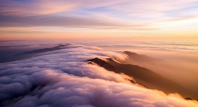 Aerial view of mountain peaks rising above a sea of clouds at sunset, with warm colors and a serene atmosphere.
