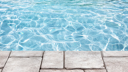 Sunlit clear pool water with stone pool deck edge, tranquil summer reflection