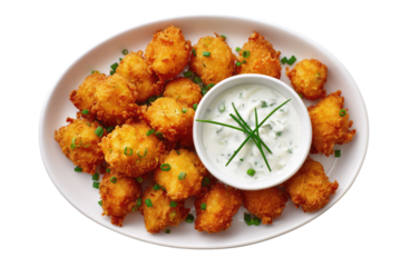 Golden, fried, savory fritters on a white oval plate, with dipping sauce and chives
