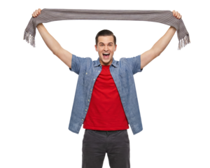 Enthusiastic young man celebrating success, raising a striped scarf overhead with palpable joy on