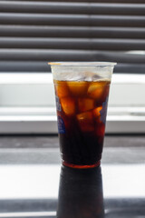 Iced black coffee in a plastic cup