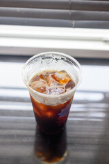 Iced black coffee in a plastic cup