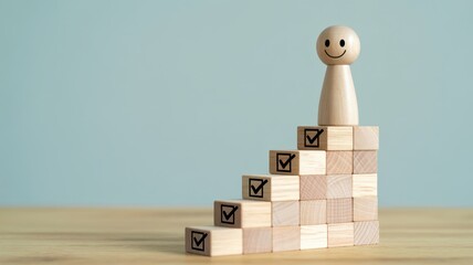 Wooden figure stands atop stacked blocks marking progress toward a goal achievement