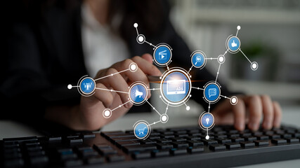 A business professional engages with a keyboard surrounded by digital marketing icons, showcasing the intersection of technology and modern advertising strategies in an office setting. Tessel