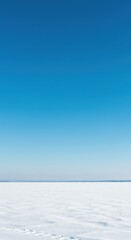 Vast, clear blue winter sky stretching endlessly above a serene, frosty landscape, conveying a sense of tranquil cold and natural beauty ,horizon ,landscape ,clear