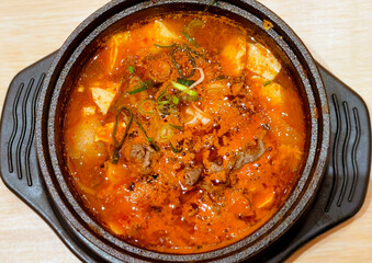 Spicy Korean Sundubu Jjigae Soft Tofu Stew with Beef and Scallions in Hot Stone Bowl