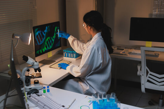 Scientist analyzing dna structure with test tube in dark lab - Powered by Adobe