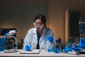 Female scientist conducting chemistry experiment in laboratory