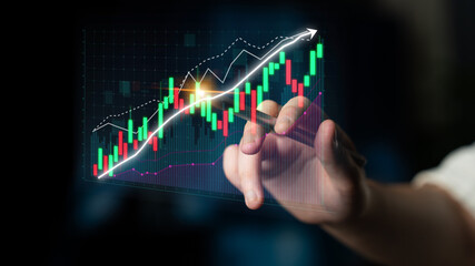 A hand interacts with a digital stock market chart displaying colorful candlestick graphs and trend lines, symbolizing investment growth and financial analysis. Impute