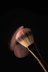 Makeup brush swirling pink powder against a dark background