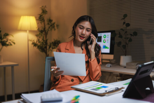 Young businesswoman working overtime managing late night tasks