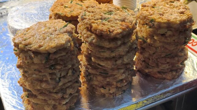 Preparing large quantities delicious street fast food. Crispy pancakes absorb frying oil, characteristic oily finish. Popular fast food choice, satisfying oily craving quickly.