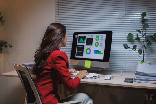 Woman analyzing data and financial reports on computer