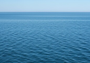 Obraz premium Vast, tranquil saltwater surface shimmering with gentle ripples under natural light. The expansive blue liquid creates a serene and pure natural background ,texture ,surface ,light