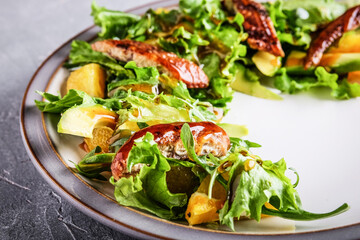 Closeup of gourmet salad showcasing prosciutto and balsamic glaze