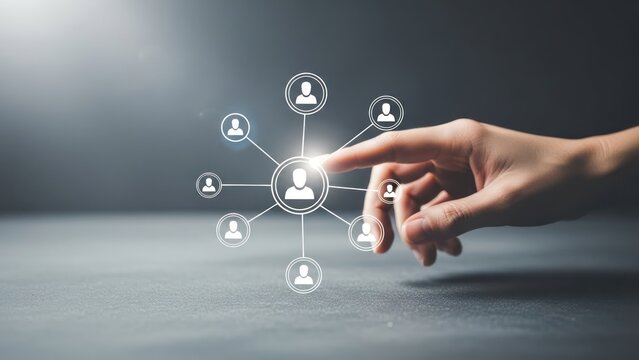 Hand interacts with network of connected people icons on a gray surface