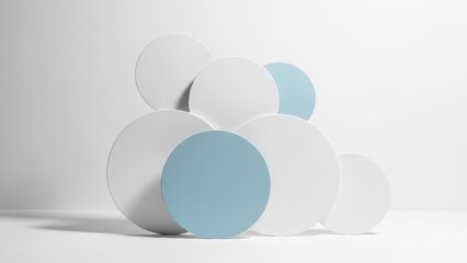 Stacked white and blue disks cast soft shadow against white wall and floor