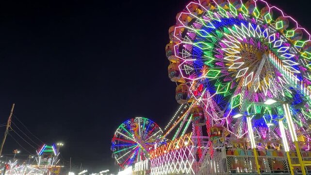 Video of Ferris Wheel or Joint wheel ride playing in night at fair ground during the annual fair.
