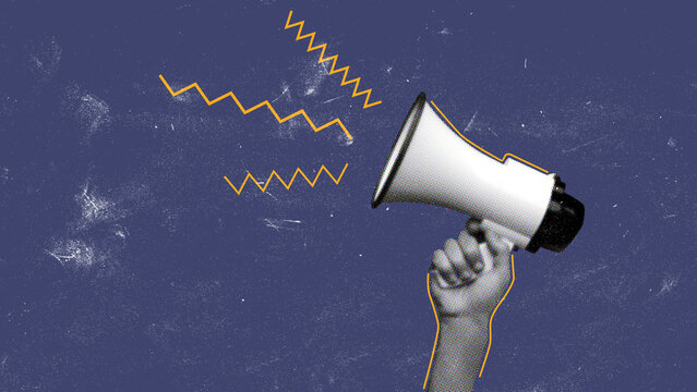 Communicators use megaphone to express ideas during a rally in an urban setting