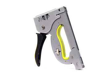 A heavy-duty manual hand stapler or hand tacker in silver-gray with an ergonomic neon yellow-green grip and a black trigger handle.