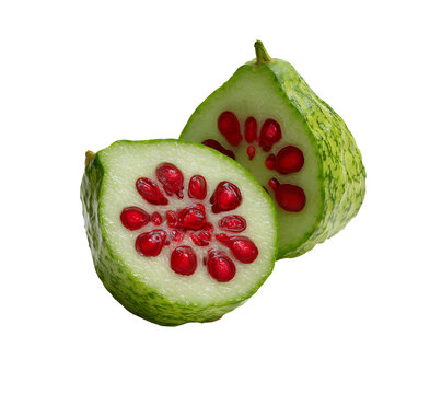 A close up of a cut cucamelon revealing its vibrant red seeds