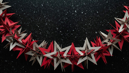 Festive garland of red and silver paper stars on a dark speckled surface creating a holiday border
