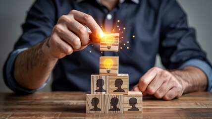 Businessman carefully places a glowing lightbulb block atop a pyramid of employee profile blocks symbolizing innovation and leadership