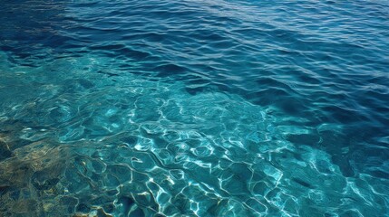 Fototapeta premium The water is calm and clear, with ripples on the surface. The sky is blue and there are no clouds in the sky