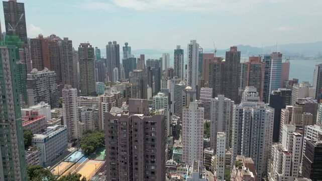 Hong Kong High Rise Building Rooftops And City China Drone Pan 4K 60FPS
