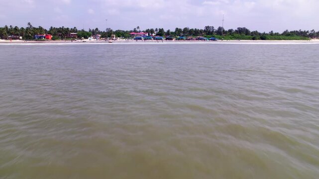 Arabian Sea with Colva Beach and trees at goa. day time, low angle shot, push in shot, drone shot, 4k.