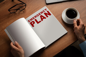 Creating a detailed emergency plan at a wooden desk with a cup of coffee