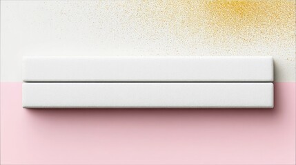 Two white rectangular objects on a pink and white background with gold glitter in a top-down view. The objects are stacked on top of each other.