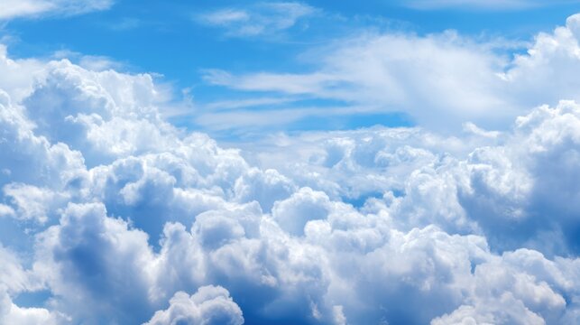 The sky is filled with fluffy white clouds, creating a serene and peaceful atmosphere. The blue sky serves as a beautiful backdrop for the clouds, making the scene feel calm and tranquil