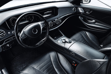 Interior of a luxurious black leather car showing elegant design and modern features