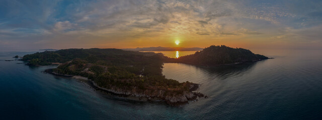 Panoramic sunrise aerial of Sakatia Island, Nosy Be, Madagascar &ndash; golden light over the ocean, tropical coastline, and peaceful island landscape.