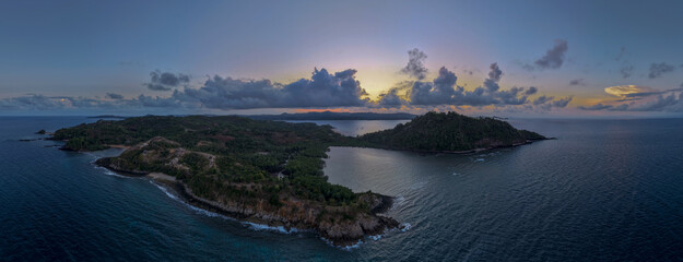 Panoramic sunset aerial of Sakatia Island, Nosy Be, Madagascar &ndash; golden light over the ocean, tropical coastline, and peaceful island landscape.