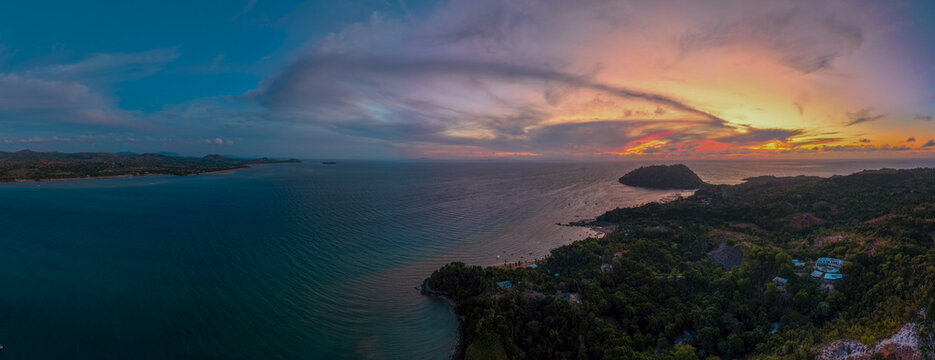 Panoramic sunset aerial of Sakatia Island, Nosy Be, Madagascar &ndash; golden light over the ocean, tropical coastline, and peaceful island landscape.